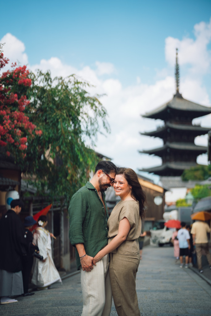 Couple romantically posing before the Yasaka Pagoda photo spot in the center of Kyoto, Japan, during a Kyoto photoshoot.